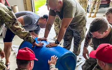 Parachute riggers with 1st SFG (A), 82nd Airborne, US Navy collaborate in building lifesaving apparatus