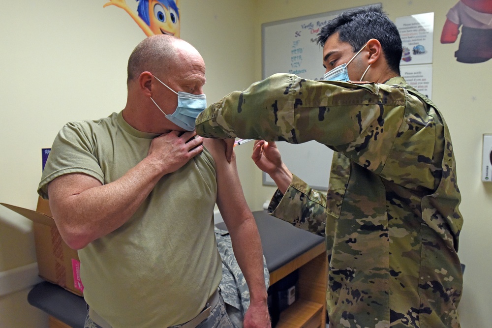 Staff Sgt. Daniel Contreras, a medical technician in the 419th Medical Squadron, administers a COVID-19 vaccine to Lt. Col. Brent Milne, a dentist in the MDS, Jan. 9, 2021, at Hill Air Force Base, Utah