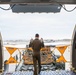 Tech. Sgt. Chris Davis, a boom operator from the 916th Air Refueling Wing, marshals a Tunner 60K aircraft cargo loader during a training exercise