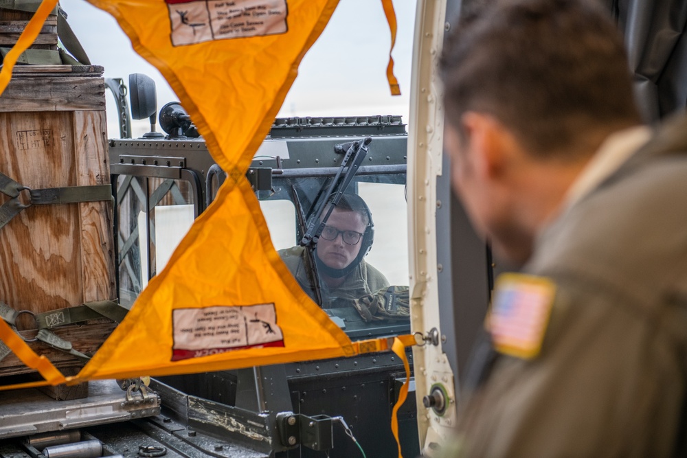 Tech. Sgt. Chris Davis, a boom operator from the 916th Air Refueling Wing, marshals Staff Sgt. Todd Rimmasch, an air transportation specialist in the 67th Aerial Port Squadron