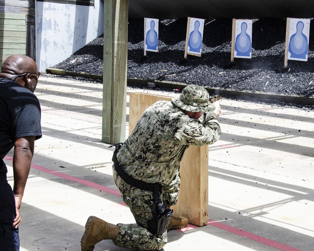 Chief Petty Officer Edward Salsberry shoots the M18 pistol from a kneeling position during a ‘move-and-shoot’ firing exercise.