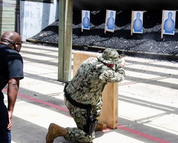 Chief Petty Officer Edward Salsberry shoots the M18 pistol from a kneeling position during a ‘move-and-shoot’ firing exercise.