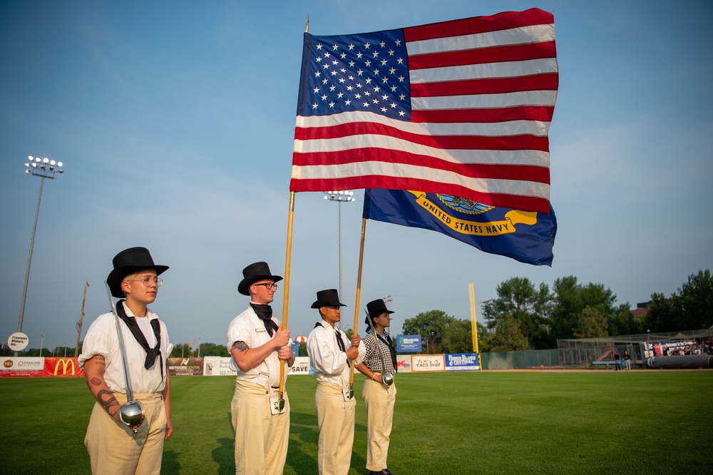 USS Constitution’s color guard presents the colors at a Red Hawks baseball game for the Fargo, North Dakota Navy week