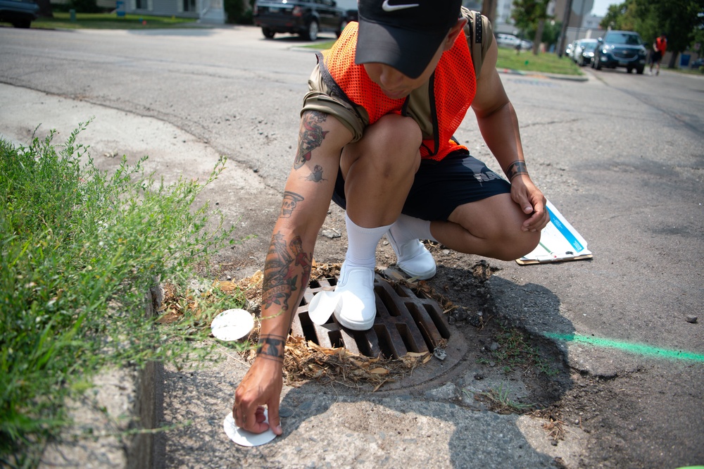USS Constitution Sailors mark sewage drains during the Fargo, North Dakota Navy week