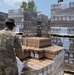 101st Airborne Division (Air Assault) Soldier unloads K-Cups for distribution.
