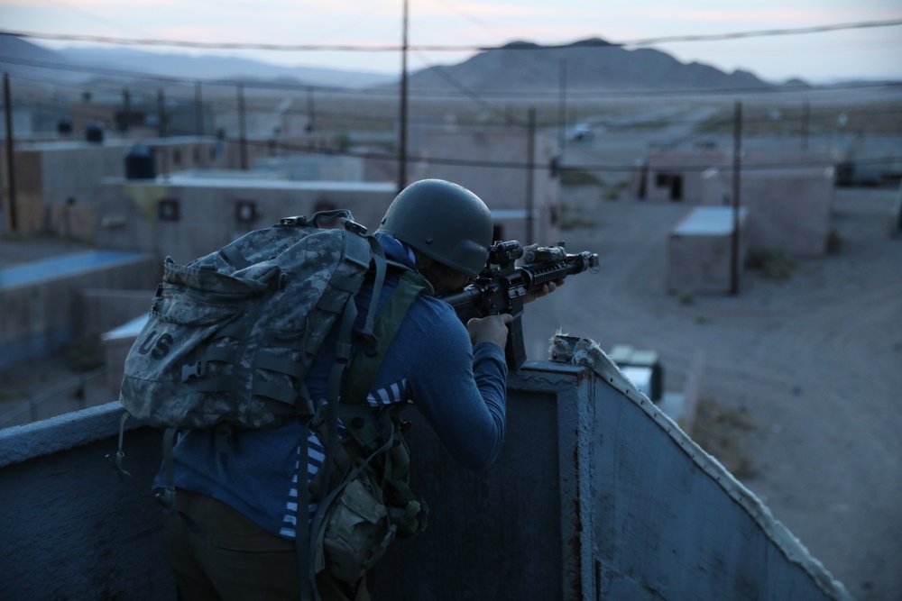 An opposition force Soldier prepares to ambush U.S. Forces as they enter the mock city of Ujen