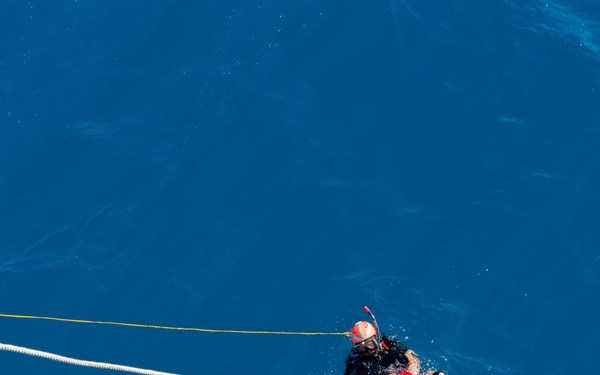 SAR swimmer retrieves "Oscar" during man overboard training.