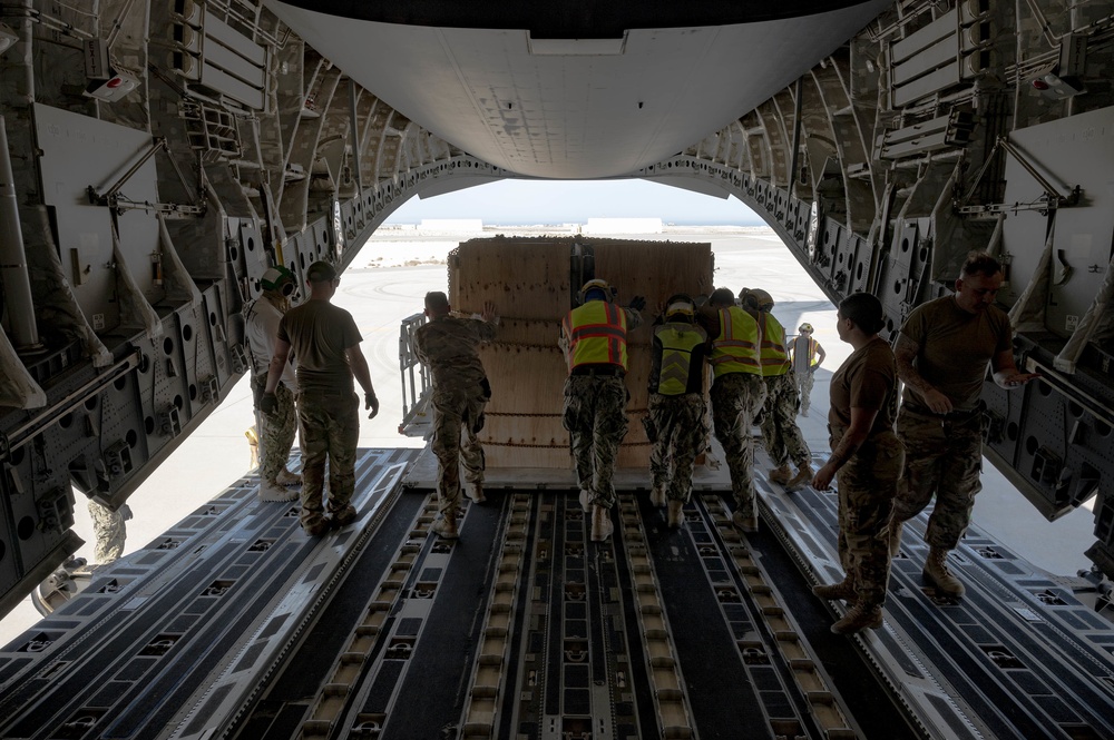 U.S. Military Members Help Unload Cargo