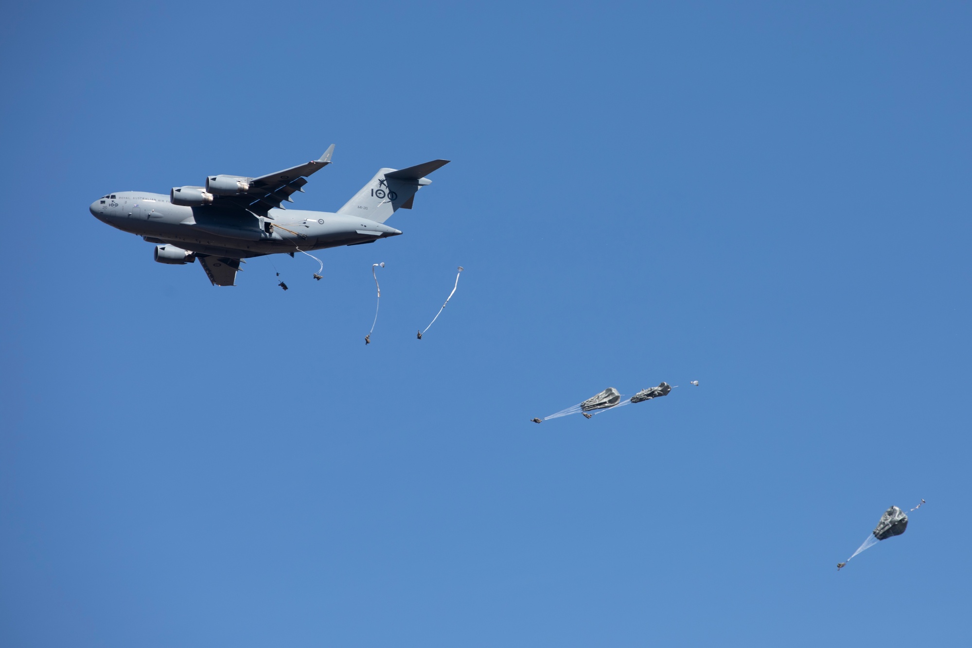 Army paratroopers jump from a C-17 Globemaster III aircraft during an  airborne training exercise on