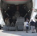 U.S., host nation Air Force members load cargo onto a Kuwait C-17 Globemaster III