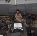 U.S., host nation Air Force members load cargo onto a Kuwait C-17 Globemaster III