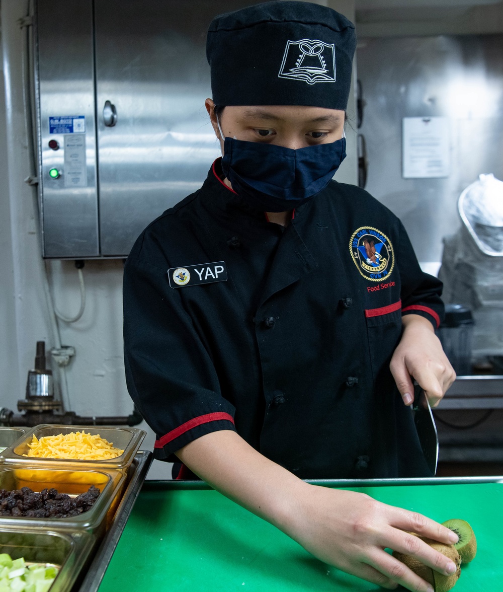 USS Carl Vinson (CVN 70) Sailor Prepares Food