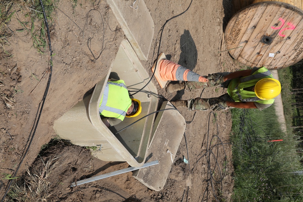 Airmen install fiber optics cables at Camp Ripley