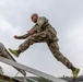 Staff Sgt. Devin Crawford jumps across an obstacle