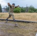 Col. Ryan “MZ” Montanez steps over an obstacle