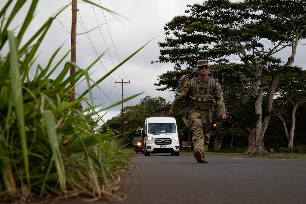 U.S. Army Master Sgt. Andrew Devito ruck marches during U.S Army Medical Command Best Leader Competition