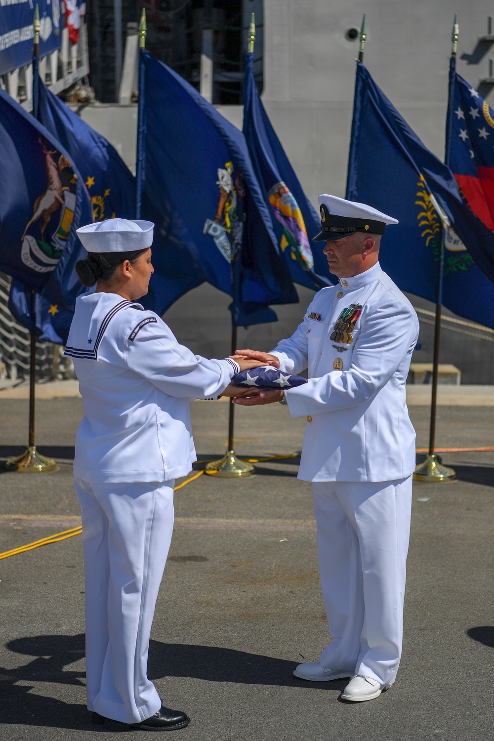 CMDCS Robert Strupczewski receives the ensign during the decommisioning of USS Independence (LCS 2)