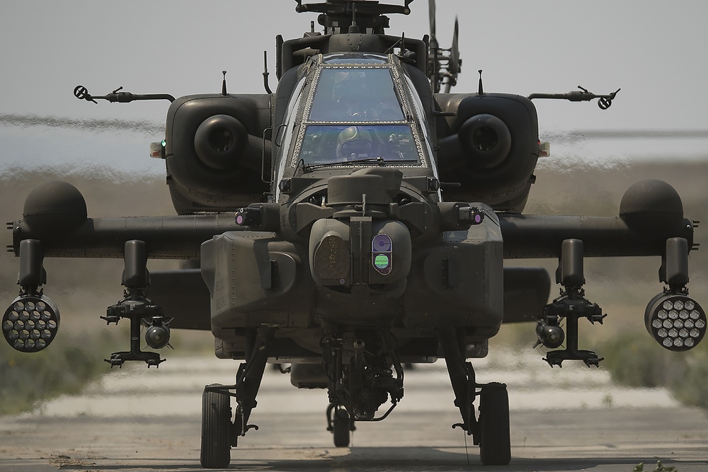  AH-64 Apache rolls onto the taxiway and to the takeoff pad.
