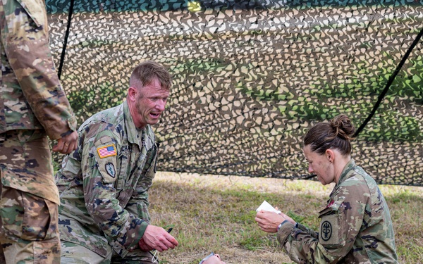 U.S. Army 1st Sgt. James Buchanan and Capt. Megan Balcom, from Regional Health Command- Central, provide medical aid during the U.S. Army Medical Command (MEDCOM) 2021 Best Leader Competition,