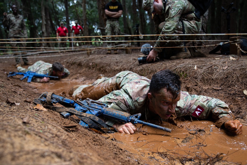 U.S. Army Cpt. Rose Ryan, 7th Special Forces Group (Airborne) Maneuvers Through The Low Crawl as he competes for Medical Soldier of the Year