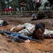 U.S. Army Cpt. Rose Ryan, 7th Special Forces Group (Airborne) Maneuvers Through The Low Crawl as he competes for Medical Soldier of the Year