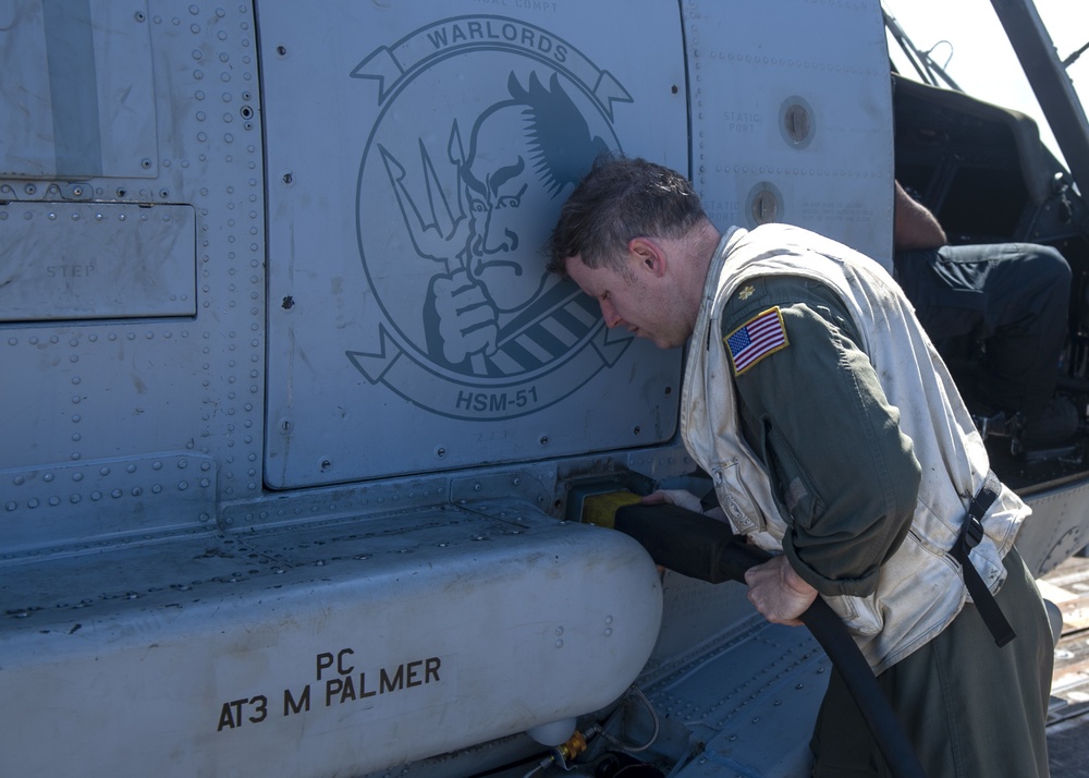 Lt. Cmdr. Steve Kohl, from Virginia Beach, V.A., conducts maintenance on an MH-60R Seahawk assigned to the “Warlords” of Helicopter Maritime Strike Squadron (HSM-51)