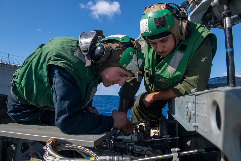 Sailors conduct maintenance on an MH-60R Seahawk assigned to the “Warlords” of Helicopter Maritime Strike Squadron (HSM-51)