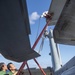 Aviation Electronics Technician 2nd Class Kayla Spencer, from Milton, Fla., conducts maintenance on an MH-60R Seahawk assigned to the “Warlords” of Helicopter Maritime Strike Squadron (HSM-51)