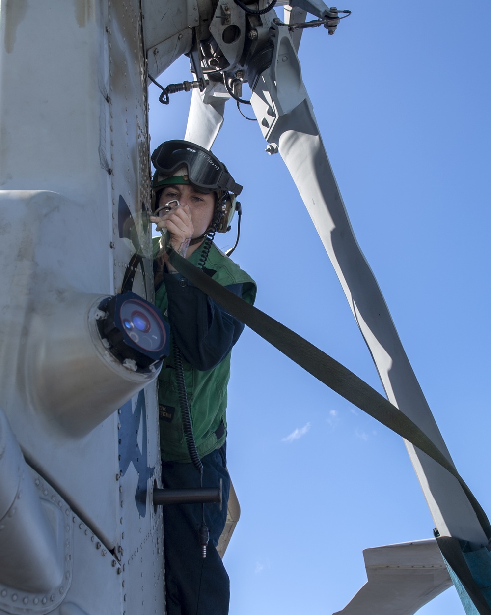 Sailors conduct maintenance on an MH-60R Seahawk assigned to the “Warlords” of Helicopter Maritime Strike Squadron (HSM-51)