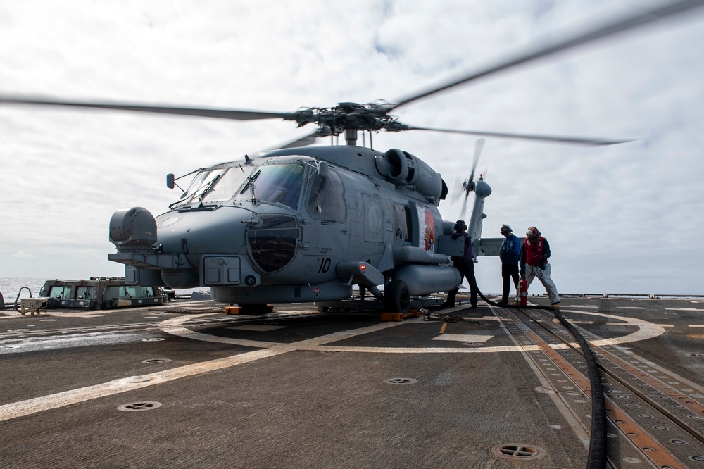 Sailors refuel an MH-60R Seahawk assigned to the “Warlords” of Helicopter Maritime Strike Squadron (HSM-51)