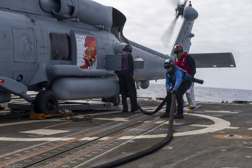 Sailors refuel an MH-60R Seahawk assigned to the “Warlords” of Helicopter Maritime Strike Squadron (HSM-51)