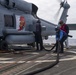 Sailors refuel an MH-60R Seahawk assigned to the “Warlords” of Helicopter Maritime Strike Squadron (HSM-51)