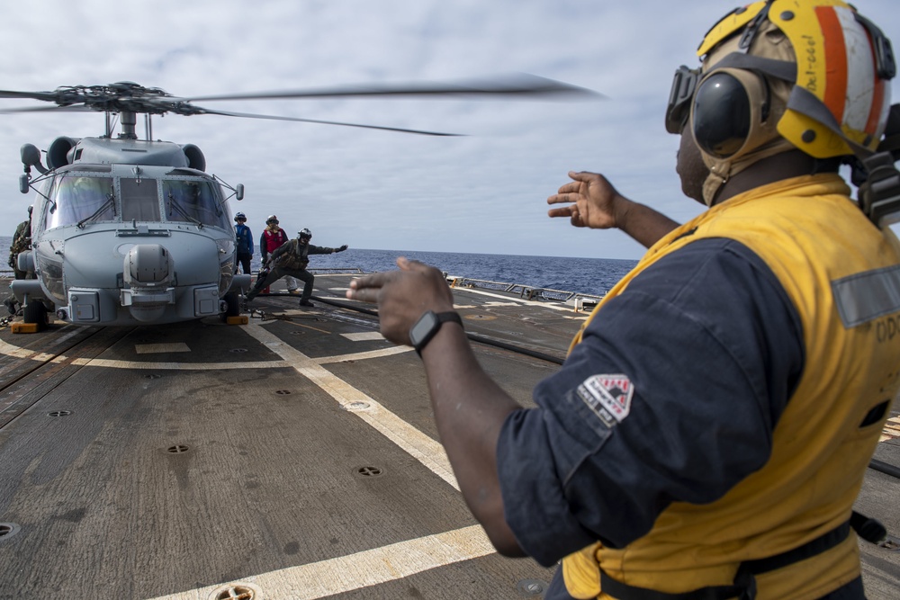 Sailors disembark an MH-60R Seahawk assigned to the “Warlords” of Helicopter Maritime Strike Squadron (HSM-51)