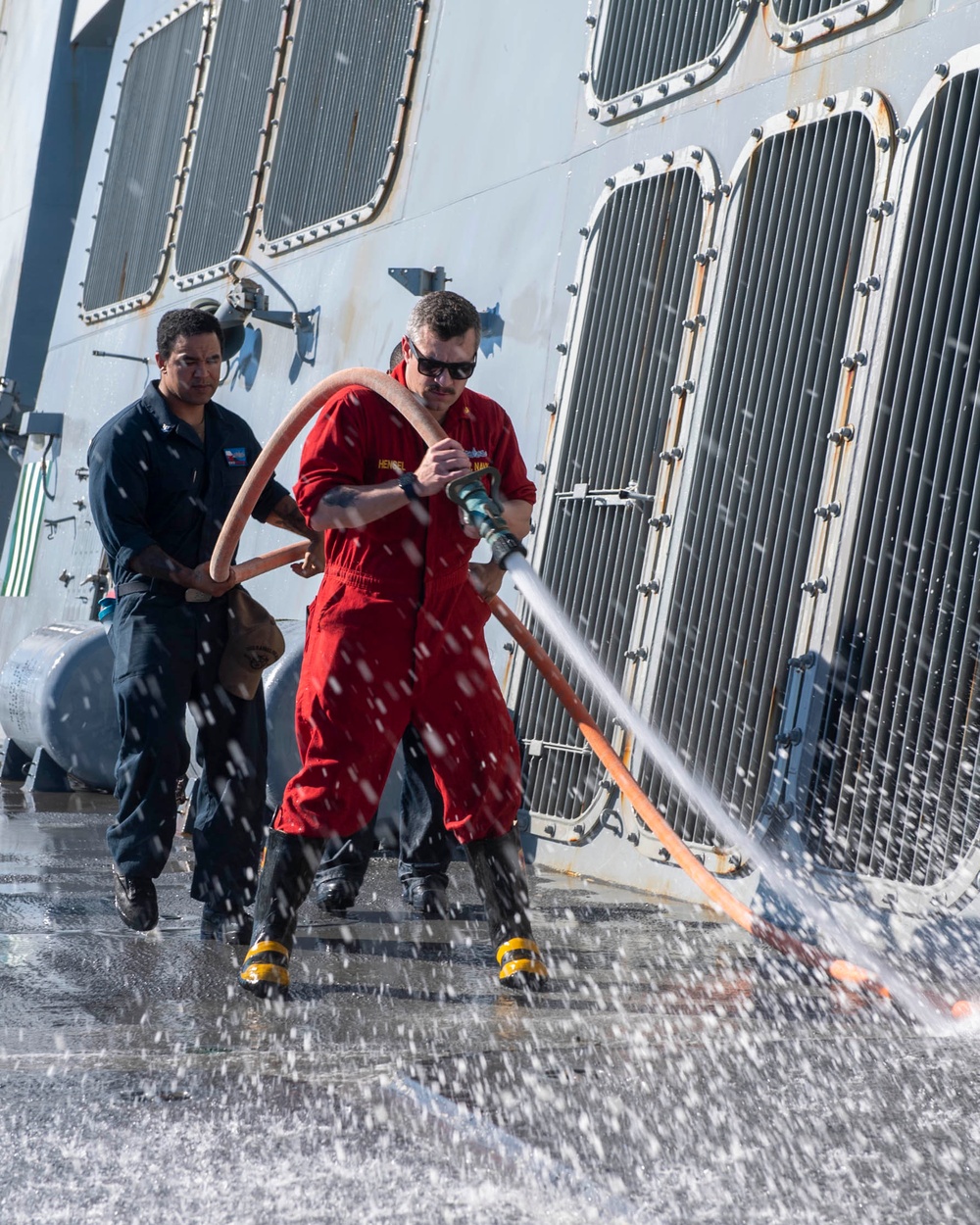 Sailors conduct a fresh-water washdown