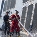 Sailors conduct a fresh-water washdown