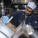 Culinary Specialist 3rd Class Ameir Baksh, from Bronx, N.Y., slices lamb in the galley