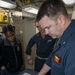 Cmdr. Charles Cooper, executive officer of USS Rafael Peralta (DDG 115), conducts an inspection with Sailors