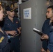 Cmdr. J.J. Murawski, commanding officer of USS Rafael Peralta (DDG 115), conducts an inspection with Sailors