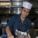 Culinary Specialist Seaman Apprentice Wendell Hidalgo, from Maui, Hawaii, prepares a gyro in the galley