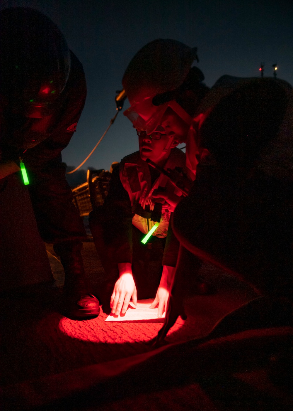 Sailors review instructions during a replenishment-at-sea (RAS)