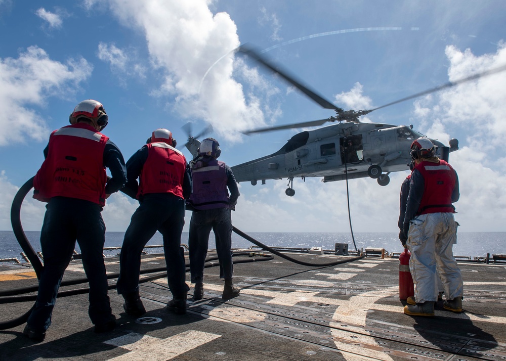 Sailors conduct a helicopter in-flight refueling (HIFI)