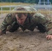 Sgt. 1st Class Shane Price crawls under an obstacle