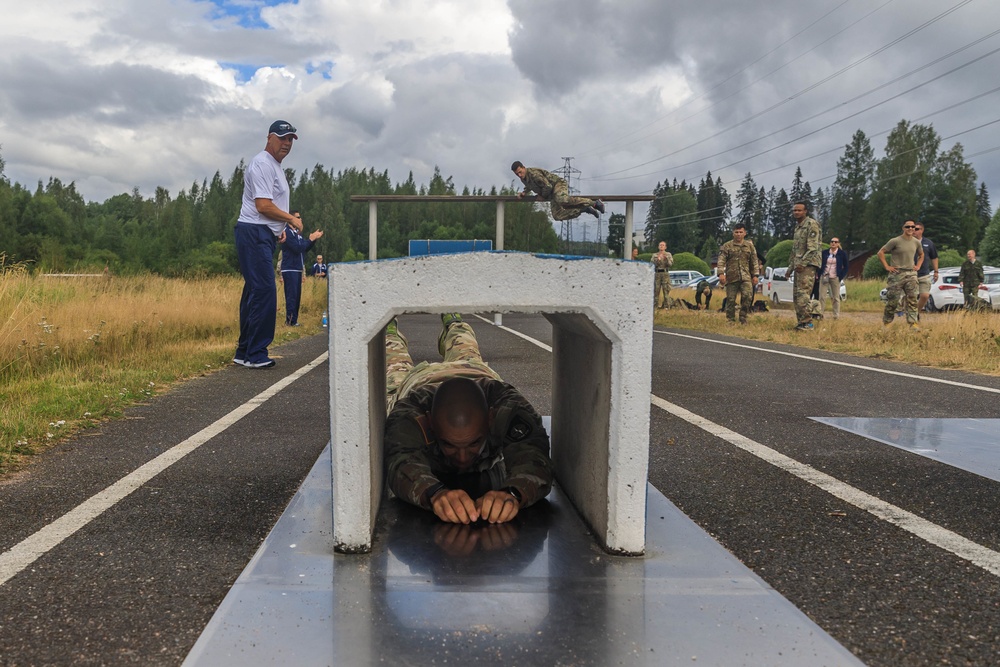 Staff Sgt. Devin Crawford slides through an obstacle