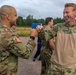 Staff Sgt. Devin Crawford congratulates Rasmus Due after completing of the land obstacle course