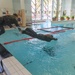 The international women's team dive into the water obstacle course