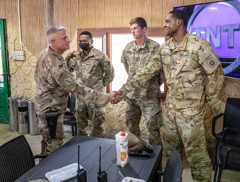 Col. Desormeaux presents coins to troops