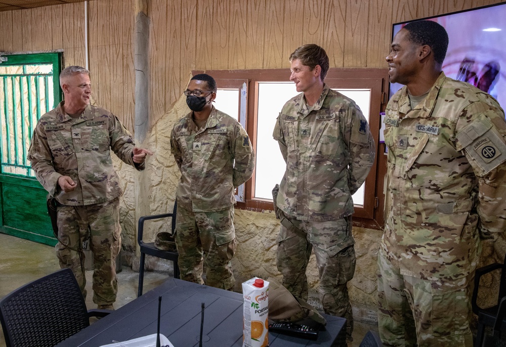 Col. Desormeaux presents coins to troops