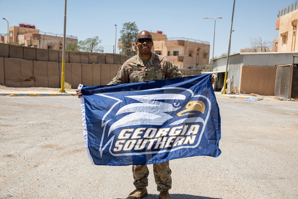 CPT Ferguson poses with flag