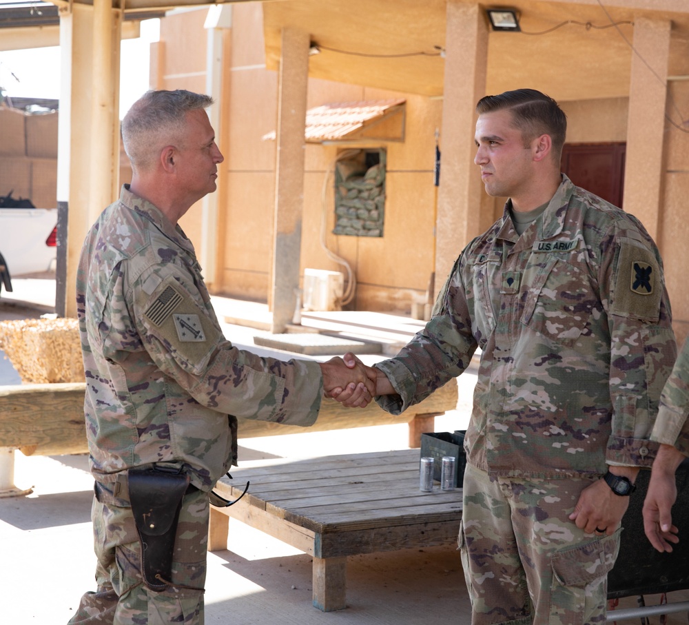 Col. Desormeaux presents coins to troops