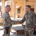 Col. Desormeaux presents coins to troops